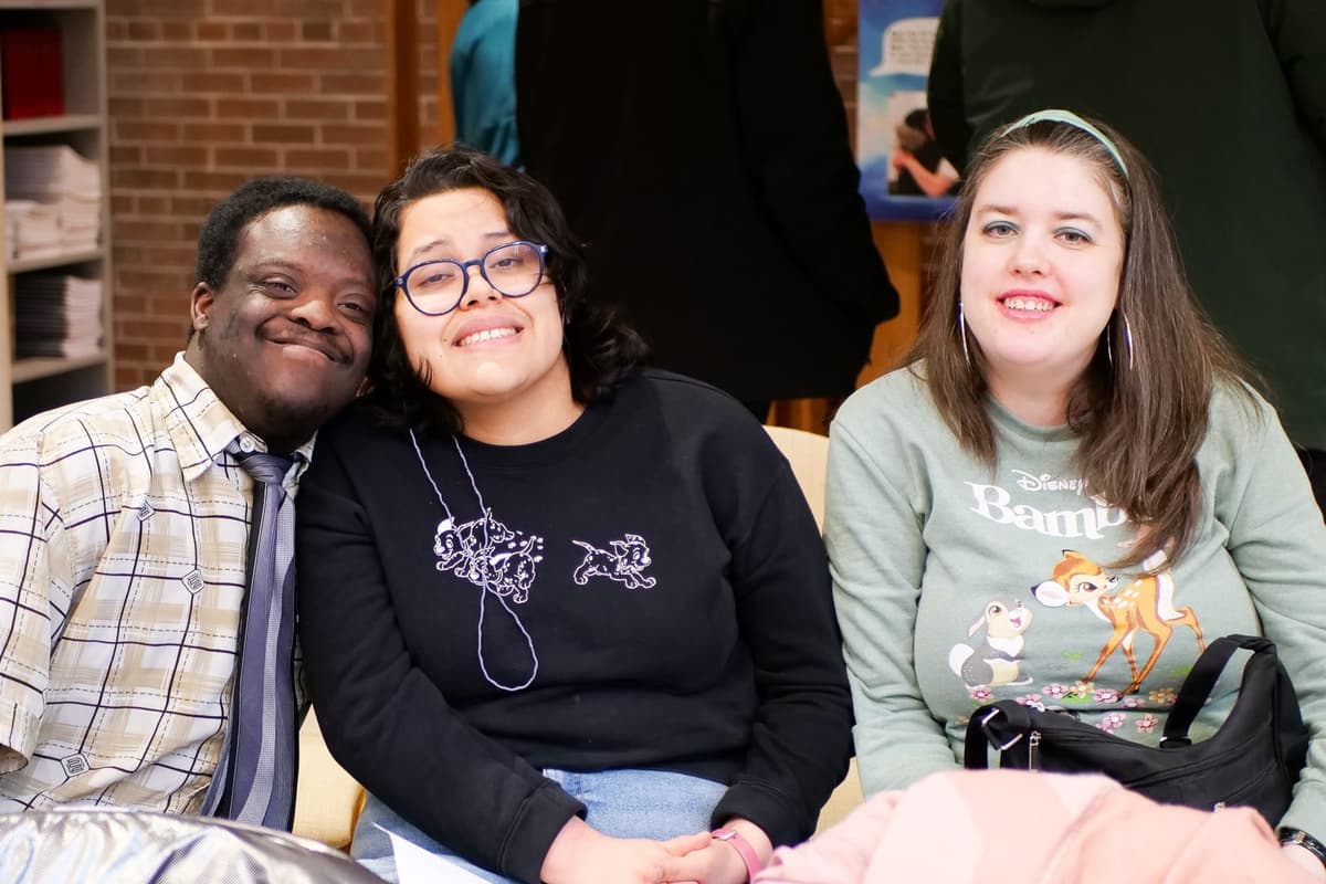 Three project participants smiling together at the Art & Vespers service